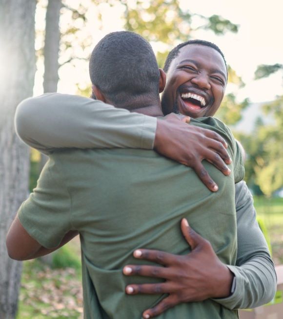 Two men hugging