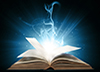 Calgary Counselling Services articles page thumbnail of a glowing book with blue lights on a black background.