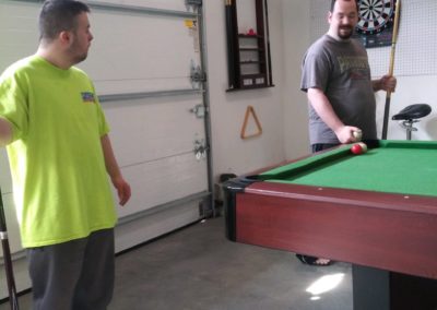 Group Home Members Playing Pool