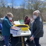 People Planting Outdoors With Masks On