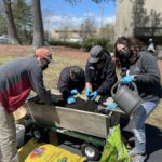 Group Of People Planting Outdoors With Masks On for Earth Day