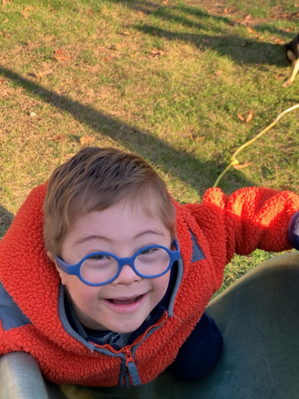 Young boy with down syndrome playing outside