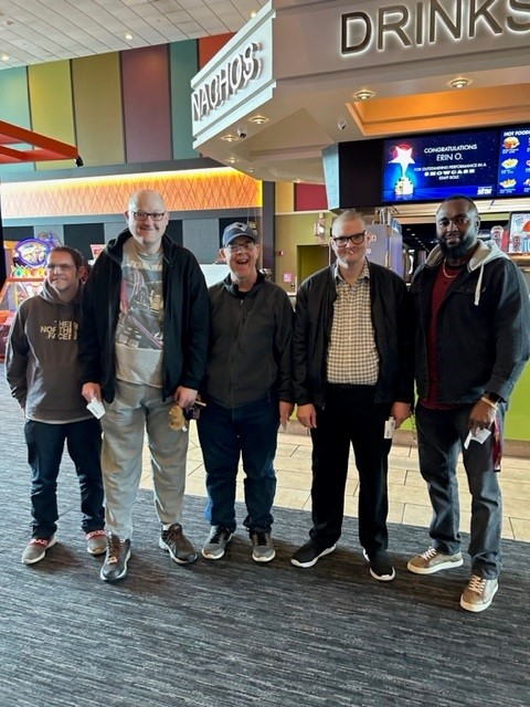 A group of men at a movie theater