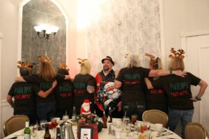 Group Of People In Reindeer Antlers With Their Backs Turned